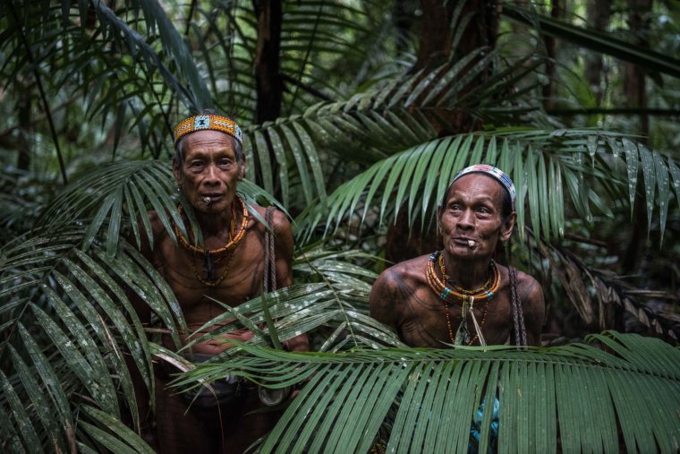 Teu Kapik Sibajak, left, and Aman Aqwi Sakkukuret, members of the Mentawai tribe, on the island of Siberut in Indonesia.